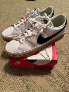 Nike Women’s White Sneakers with Black Swoosh and Gum Sole with original box.